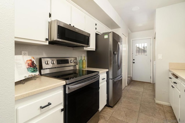 kitchen with white cabinets, stainless steel appliances, and light tile patterned floors