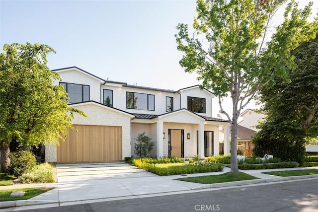 modern inspired farmhouse with a garage