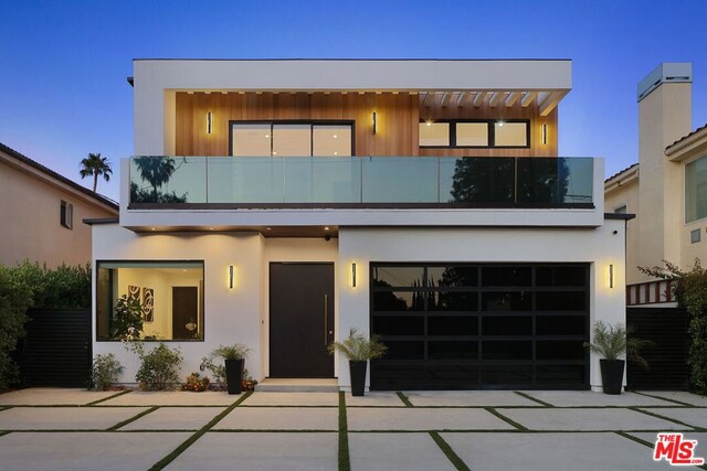 contemporary home with a balcony and a garage