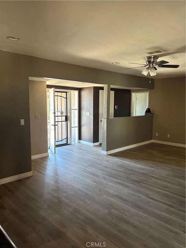 spare room with ceiling fan and dark wood-type flooring