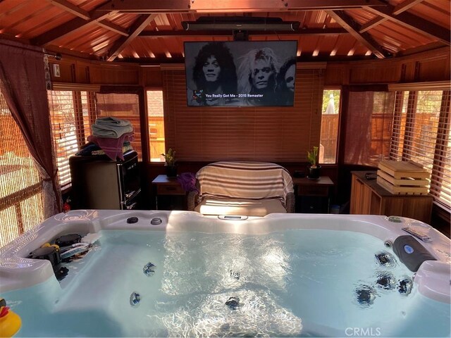 view of swimming pool featuring a hot tub