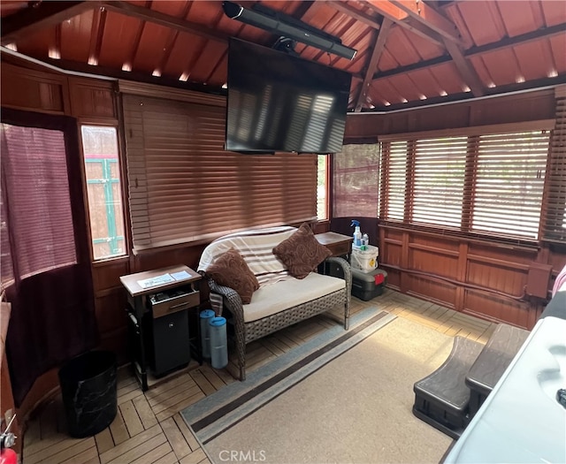 sunroom / solarium with lofted ceiling with beams