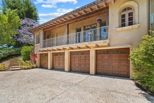 exterior space featuring a garage and a balcony