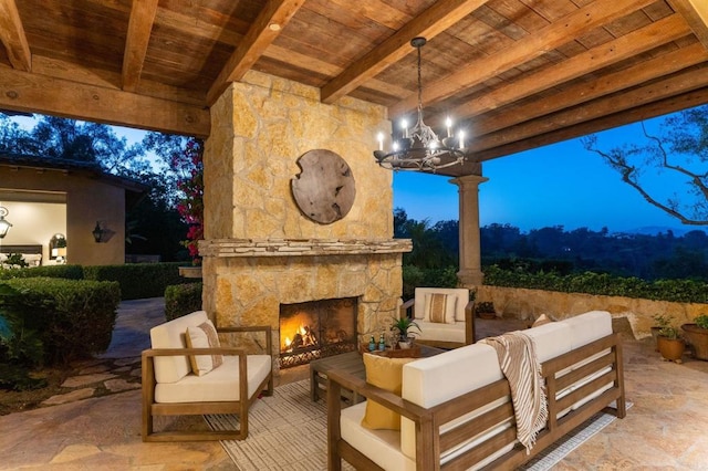 patio terrace at dusk with an outdoor stone fireplace