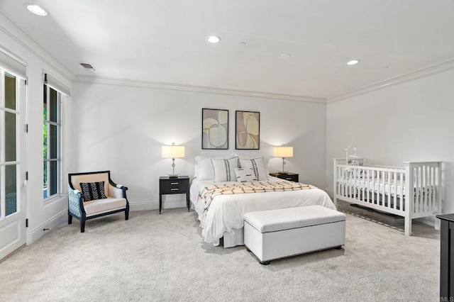 bedroom with crown molding and light colored carpet