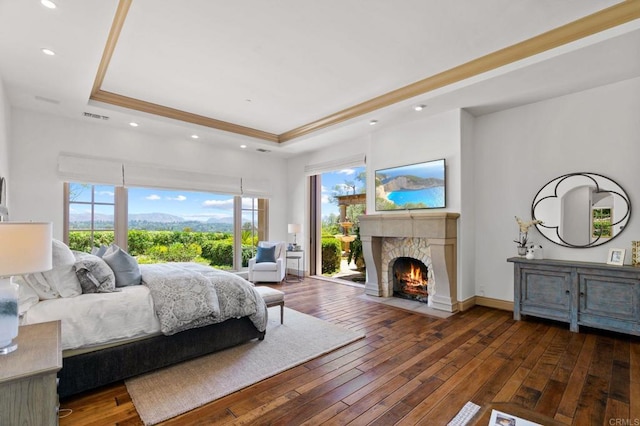 bedroom with dark hardwood / wood-style flooring and a tray ceiling