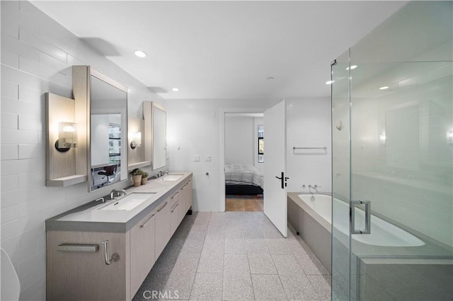 bathroom with hardwood / wood-style flooring, vanity, tile walls, and independent shower and bath