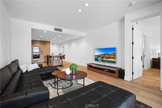 living room with light hardwood / wood-style flooring