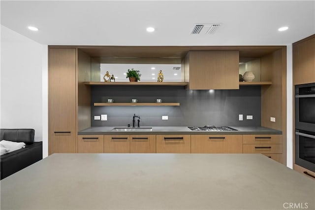 kitchen featuring appliances with stainless steel finishes, tasteful backsplash, and sink