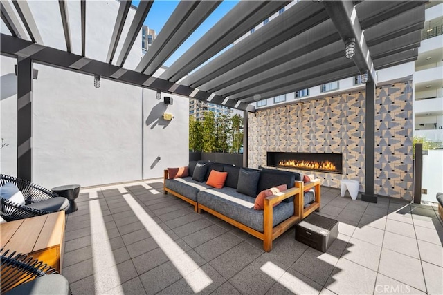 view of patio featuring an outdoor living space with a fireplace