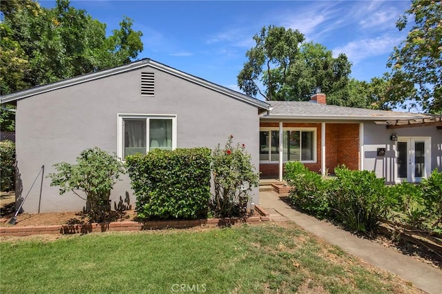 1116 Sheridan Ave, Chico, CA 95926 - exterior space featuring stucco siding, a chimney, brick siding, and a front yard