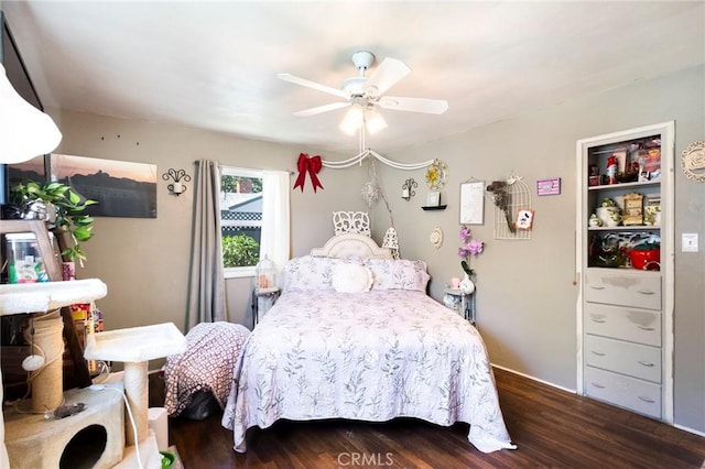 bedroom with ceiling fan and dark hardwood / wood-style flooring