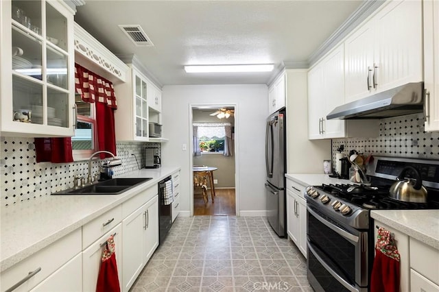 kitchen featuring sink, stainless steel appliances, tasteful backsplash, white cabinets, and light tile patterned flooring