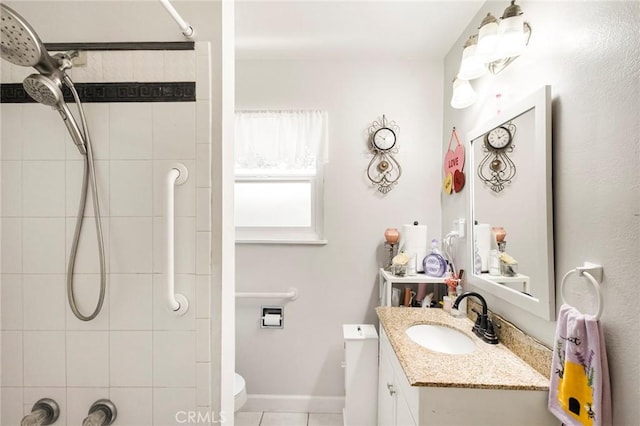 bathroom featuring vanity, tiled shower, tile patterned floors, and toilet