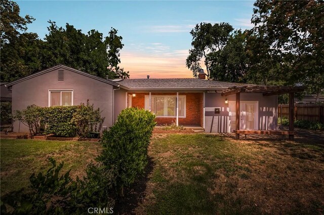 1116 Sheridan Ave, Chico, CA 95926 - back of property with a lawn, fence, roof with shingles, and stucco siding
