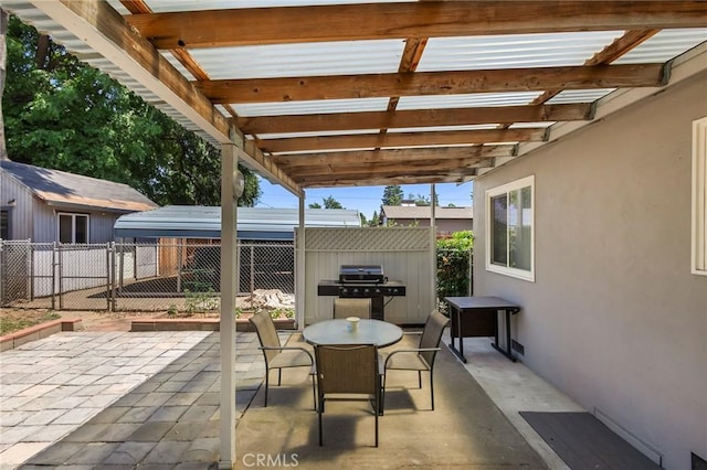 view of patio featuring a grill and a shed