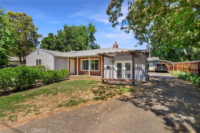 1116 Sheridan Ave, Chico, CA 95926 - ranch-style house featuring driveway, french doors, a chimney, a detached carport, and fence