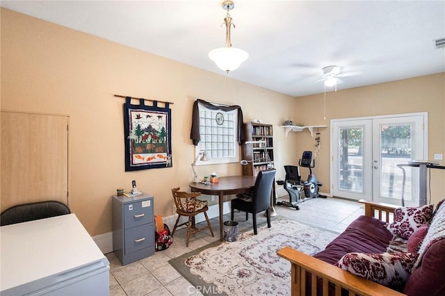 home office featuring light tile patterned flooring, ceiling fan, and french doors