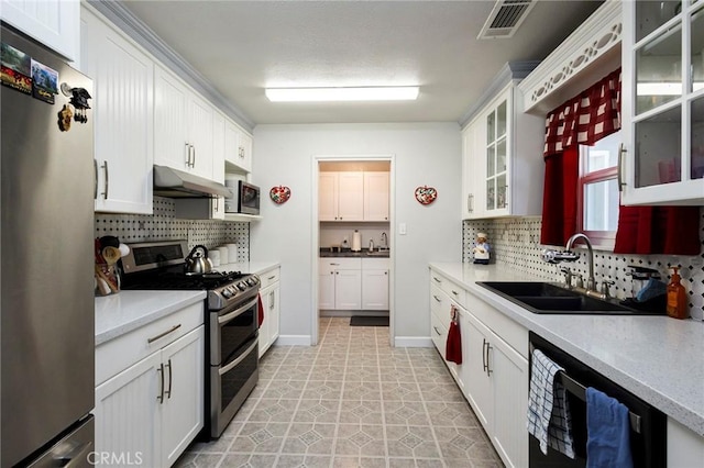 kitchen with white cabinetry, sink, backsplash, light tile patterned floors, and stainless steel appliances