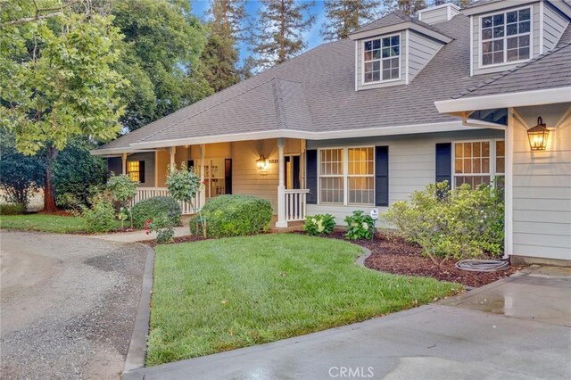 view of front of home with a front yard and a porch