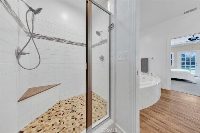 bathroom featuring independent shower and bath, ceiling fan, hardwood / wood-style floors, and crown molding