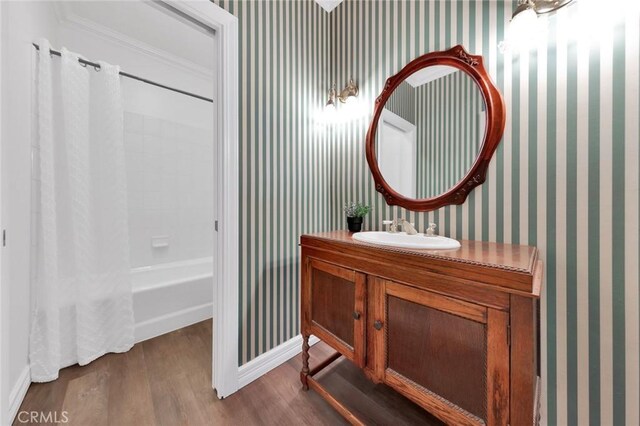 bathroom with wood-type flooring, vanity, and shower / bath combo