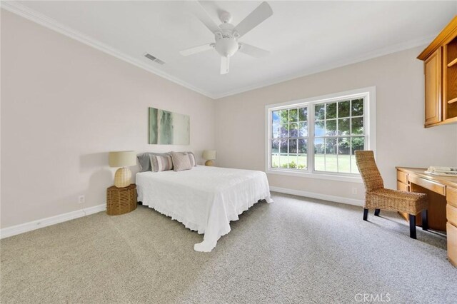 bedroom featuring ornamental molding, light colored carpet, and ceiling fan