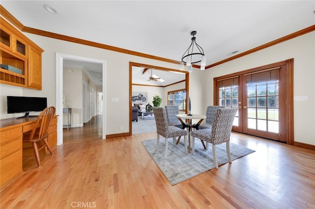 dining area with light hardwood / wood-style floors, ceiling fan, french doors, and crown molding