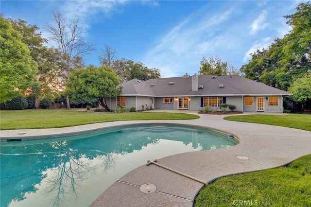 view of pool with a yard