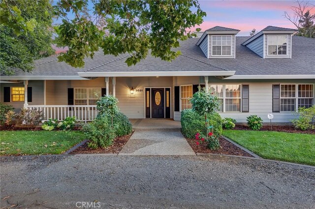 view of front facade featuring a lawn and a porch