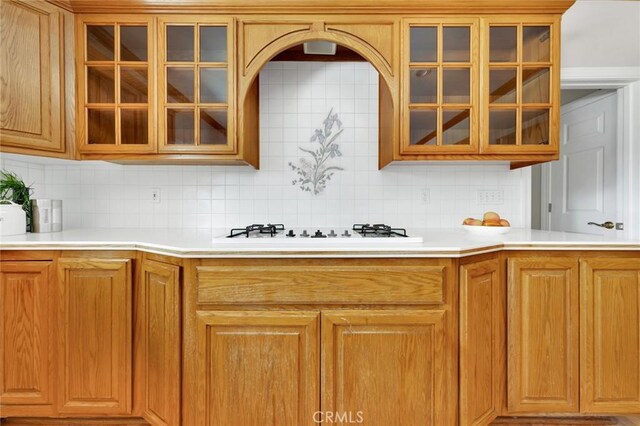 kitchen featuring white gas cooktop and tasteful backsplash