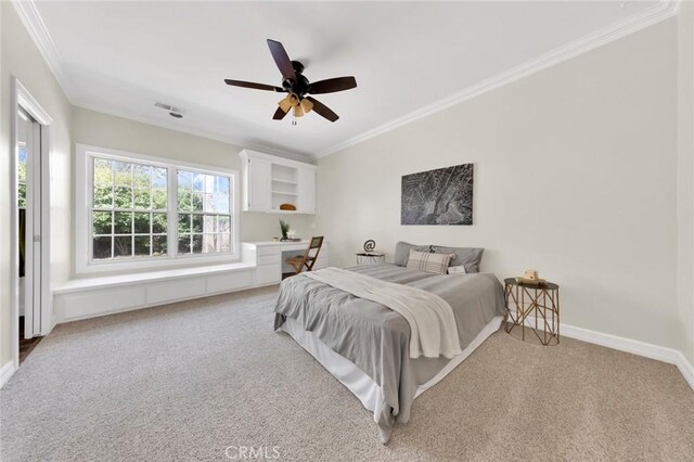 carpeted bedroom with ceiling fan and crown molding