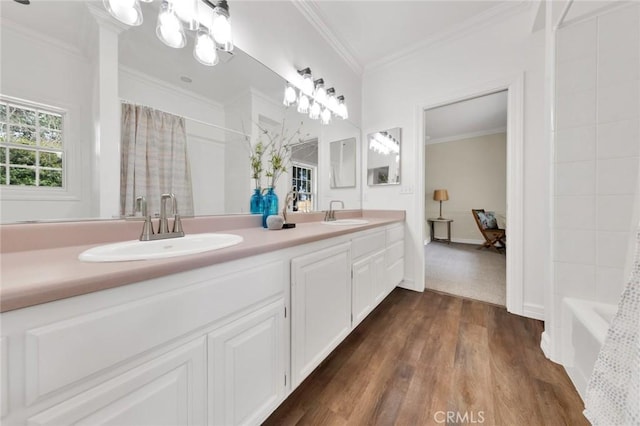 bathroom with vanity, shower / bath combination with curtain, hardwood / wood-style flooring, and ornamental molding