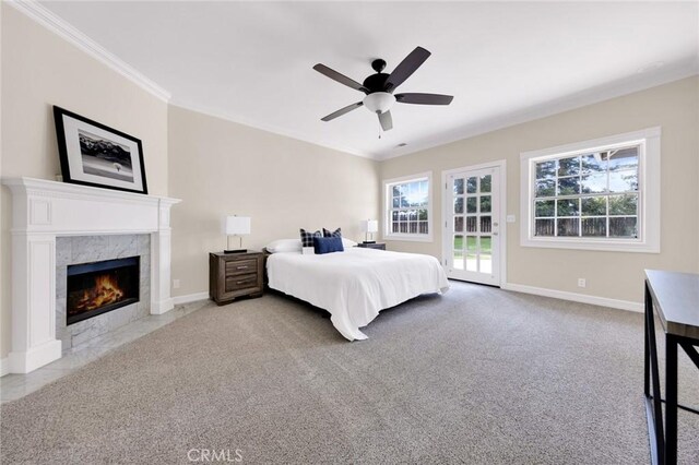 bedroom featuring carpet flooring, a fireplace, ceiling fan, and access to outside