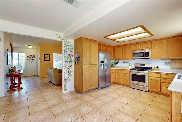 kitchen featuring appliances with stainless steel finishes and light tile patterned floors