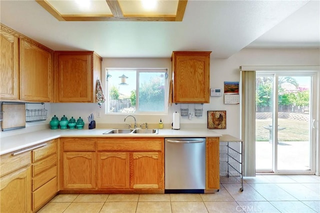 kitchen with sink, light tile patterned floors, and stainless steel dishwasher