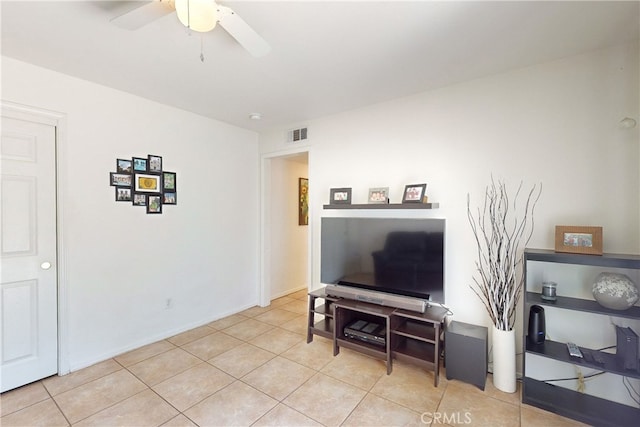 tiled living room featuring ceiling fan