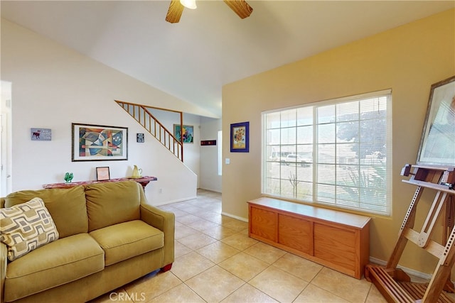 living room with ceiling fan, light tile patterned floors, and lofted ceiling