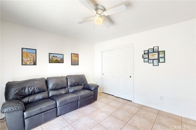 tiled living room with ceiling fan