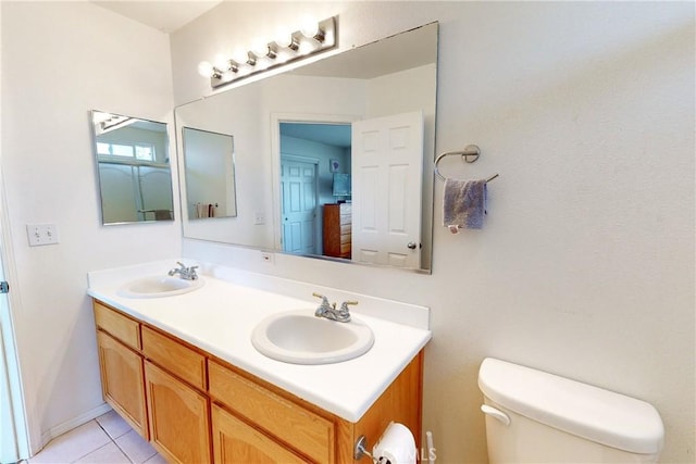 bathroom with tile patterned floors, vanity, and toilet