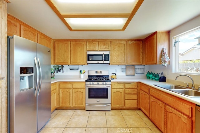 kitchen featuring sink, light tile patterned floors, and appliances with stainless steel finishes