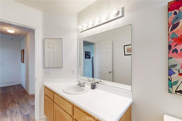 bathroom with hardwood / wood-style floors and vanity