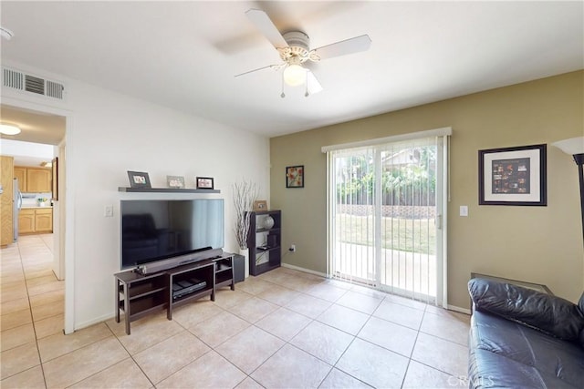 tiled living room with ceiling fan