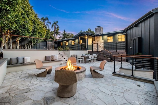 patio terrace at dusk with an outdoor fire pit