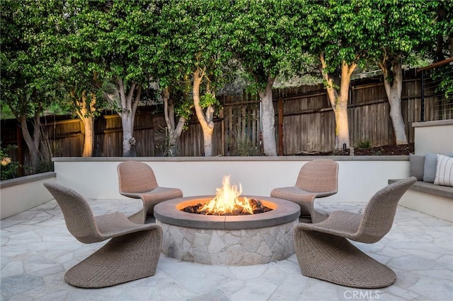 view of patio / terrace featuring an outdoor fire pit