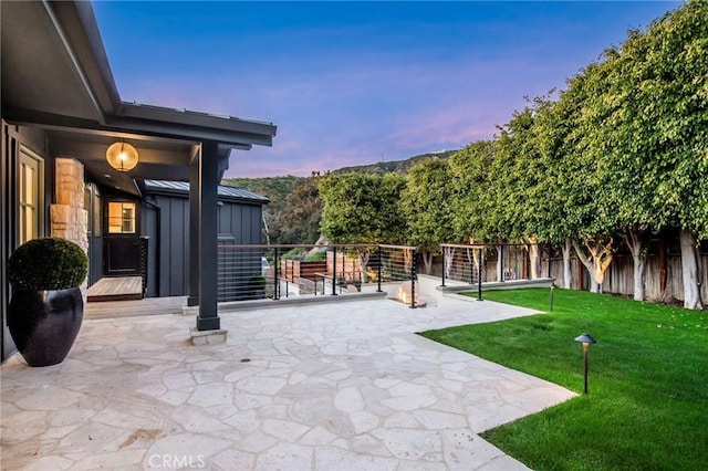 patio terrace at dusk with a yard