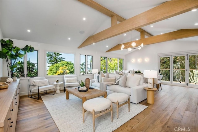 living room with beamed ceiling, light wood-type flooring, and plenty of natural light