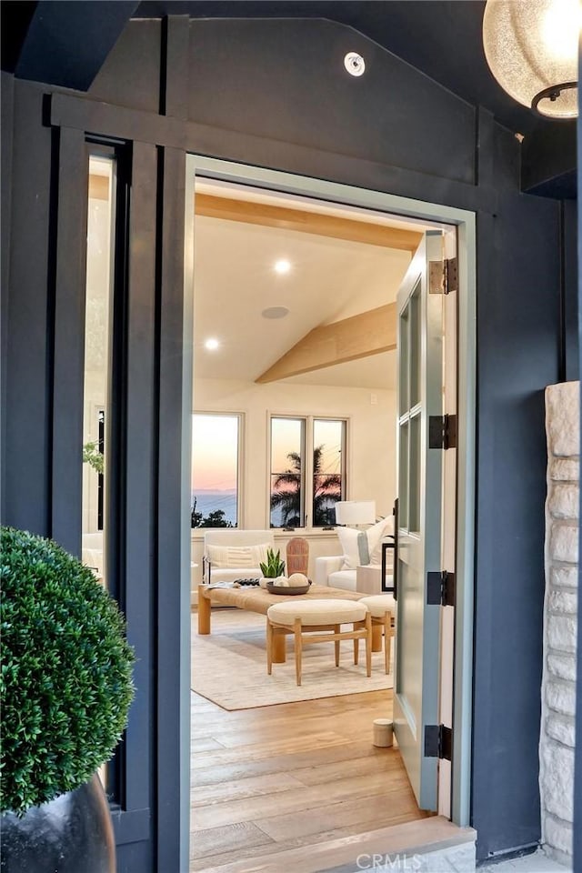 doorway featuring hardwood / wood-style flooring and lofted ceiling