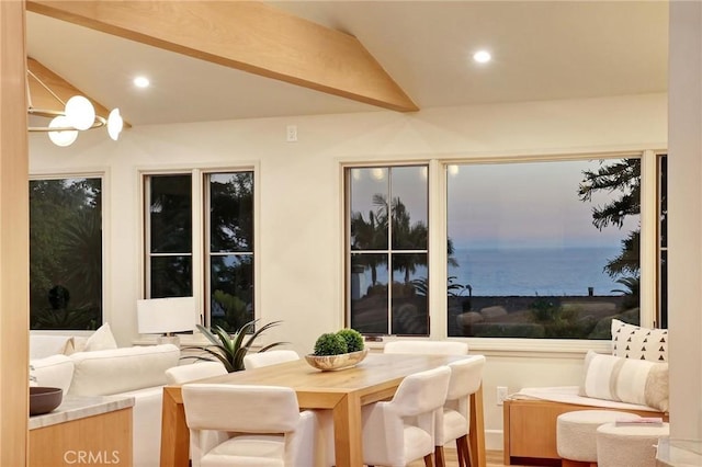 sunroom / solarium featuring an inviting chandelier and vaulted ceiling