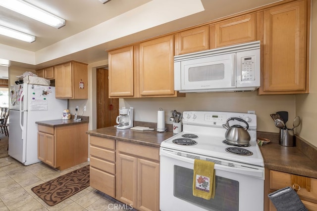 kitchen with light tile patterned flooring, white appliances, and light brown cabinets